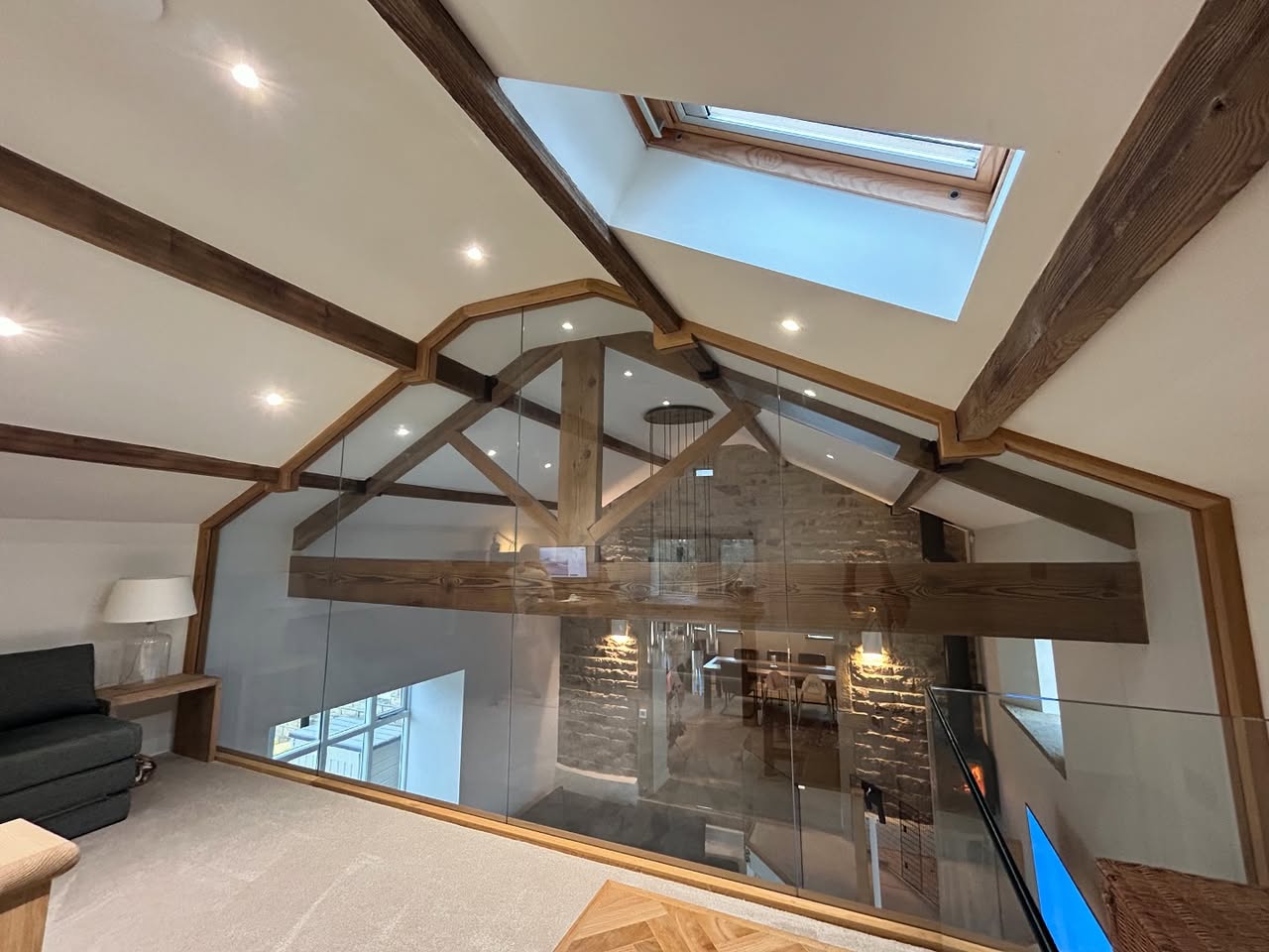 Glazed mezzanine wall in a converted farmhouse barn